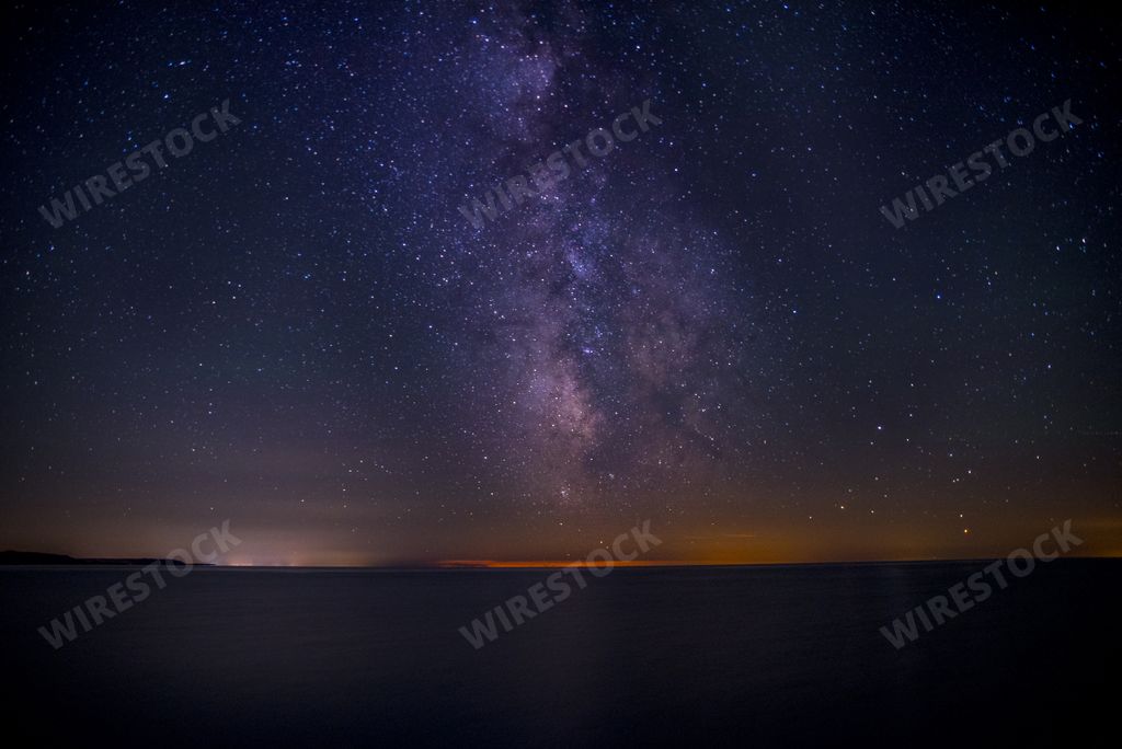 A beautiful shot of the dark purple sky filled with stars at the night