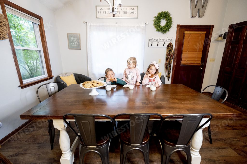 A closeup shot of a happy family eating chocolate chips and drinking milk - family concept