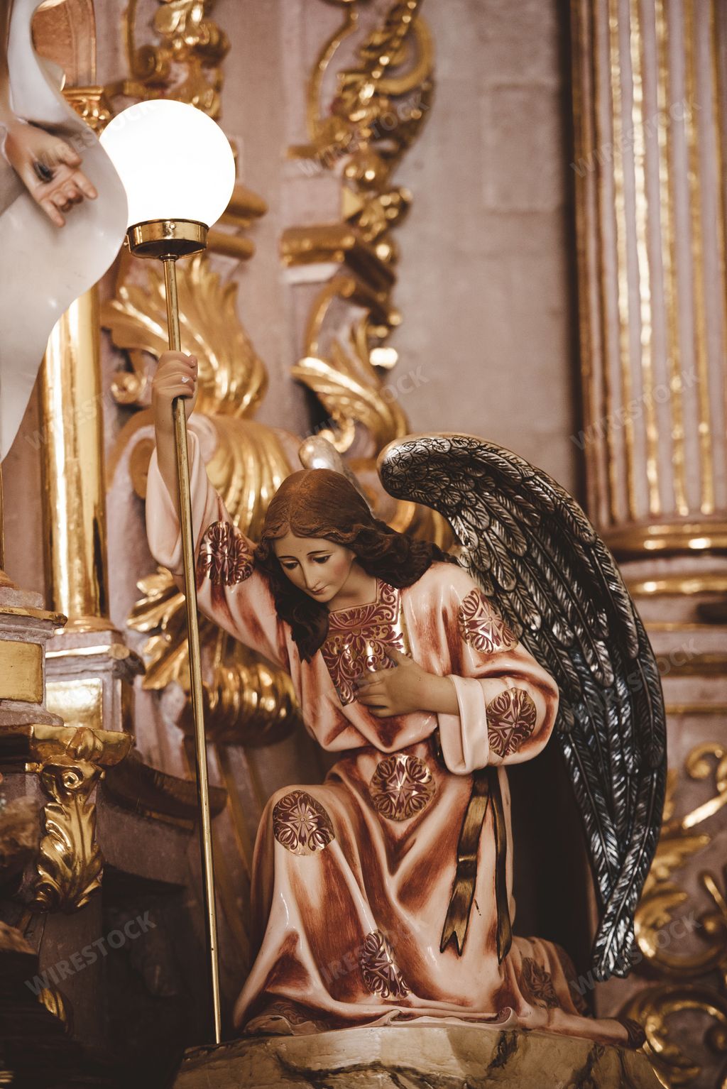 A vertical shot of an angel statue in the church with blurred background in Zacatecas Mexico