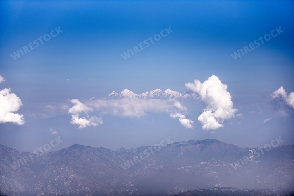 A beautiful shot of Himalaya Mountains Nepal in the distance with a blue sky in the background