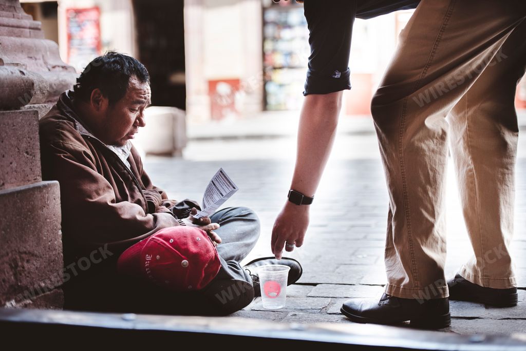 A Mexican beggar on the side of the road begging for money and food