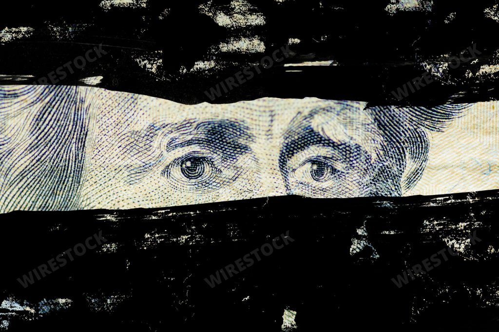A closeup shot of the Andrew Jackson, face on the dollar bill with lines painted over it
