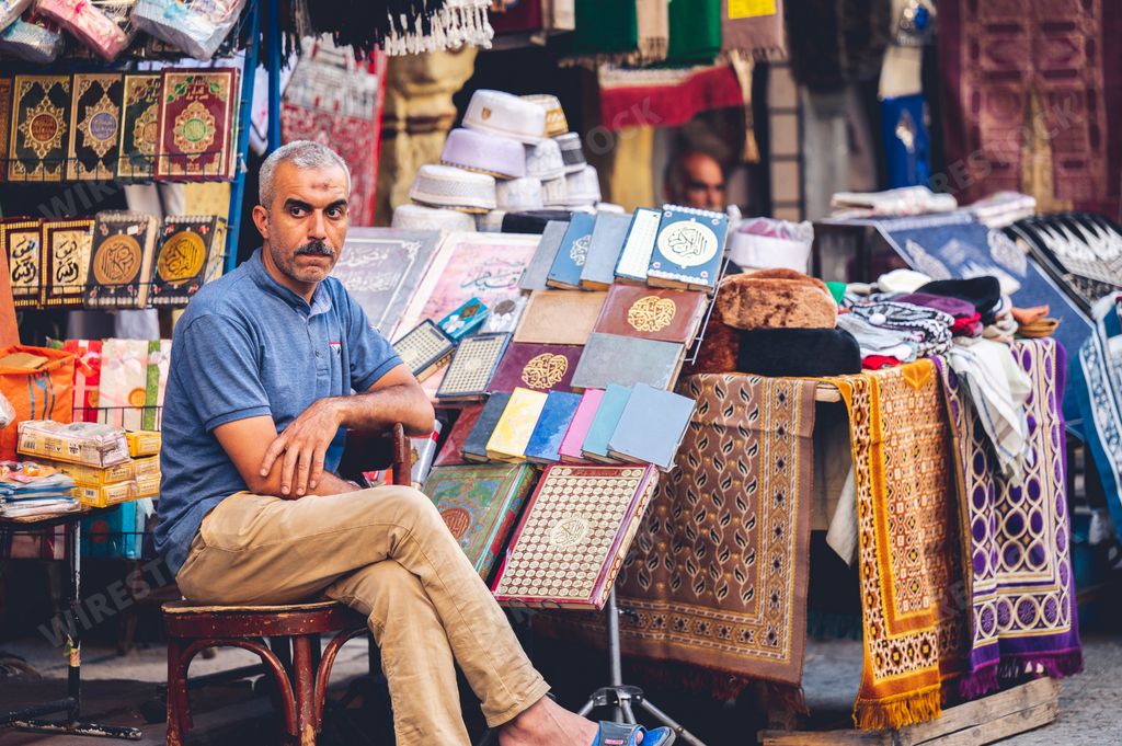 A closeup shot an Egyptian man on the market selling different traditional objects