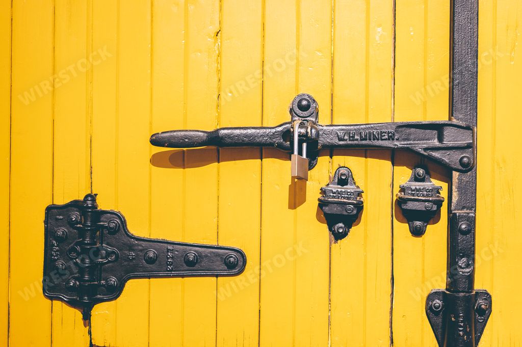 A historic yellow train door on a hundred-year-old train