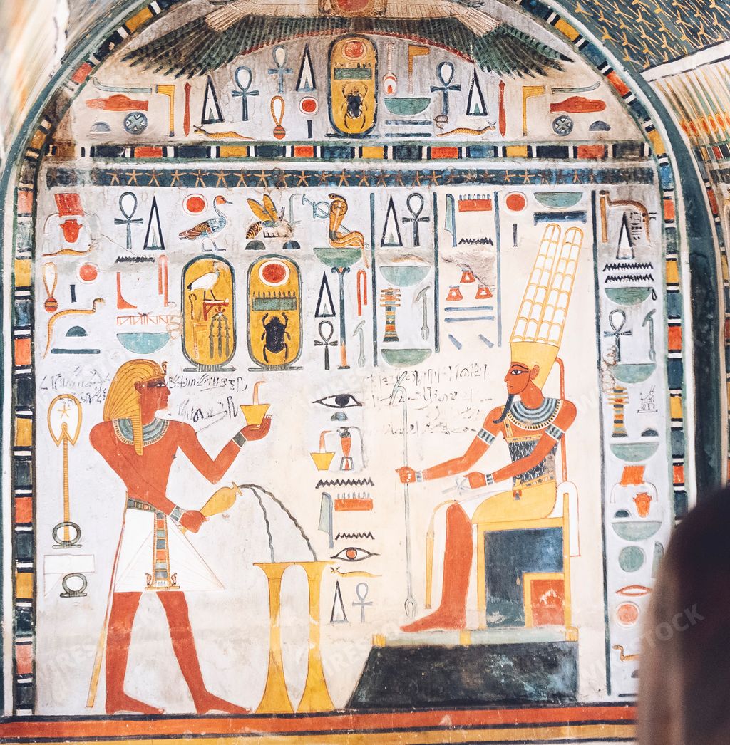 A painted white slab of stone depicting Osiris receiving offerings on his throne in the Egyptian Museum in Cairo