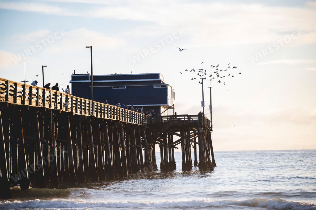 A beautiful view of the pier at Newport Beach under a dramatic cloudy sky, California