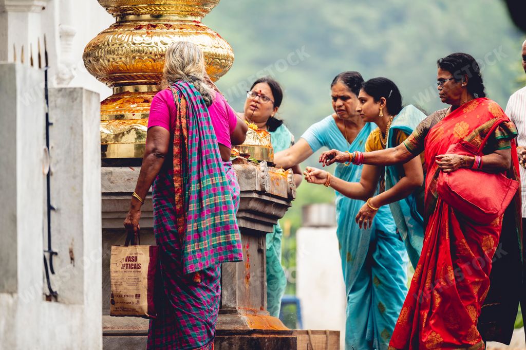 The women praying to idols and guards at the Narasimha Hindu temple in Visakhapatnam India