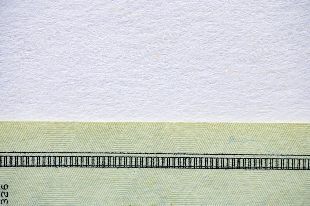 A white surface with a dollar bill on the bottom - great for background or writing text