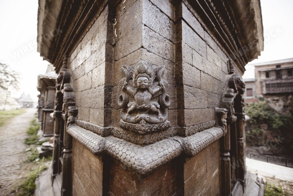 A closeup shot of a wall with sculpting at a Hindu temple in Nepal
