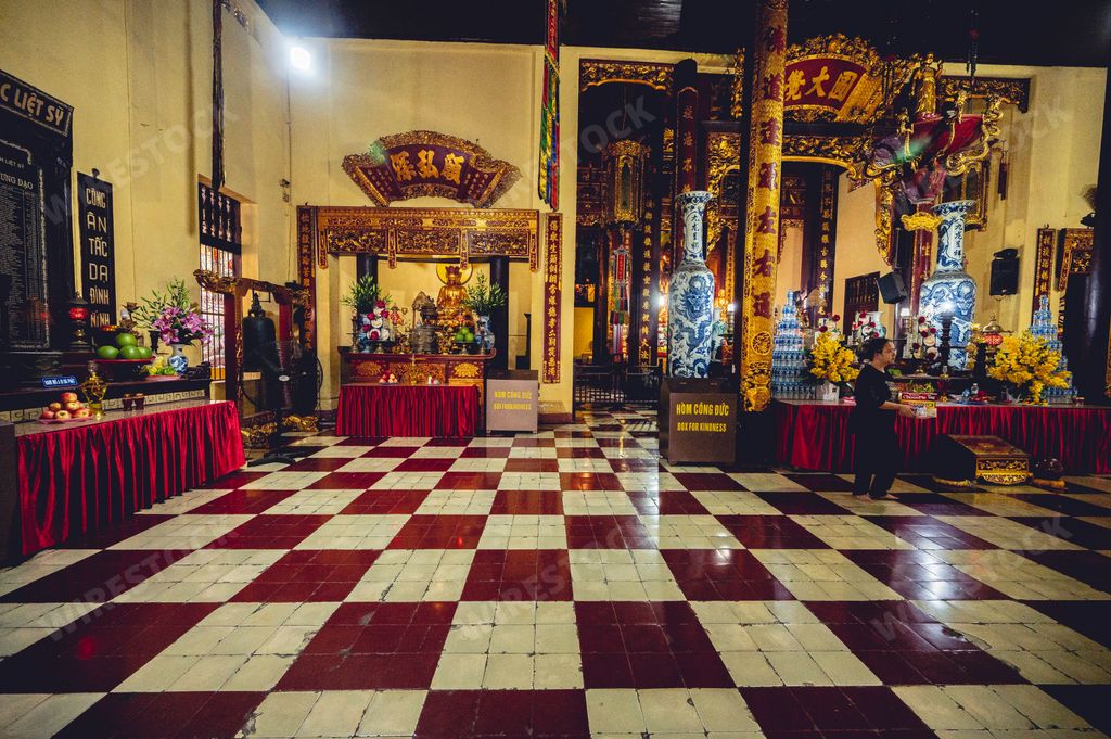 The interior of a beautiful adorned Buddhist Temple with idols and decorations in Vietnam