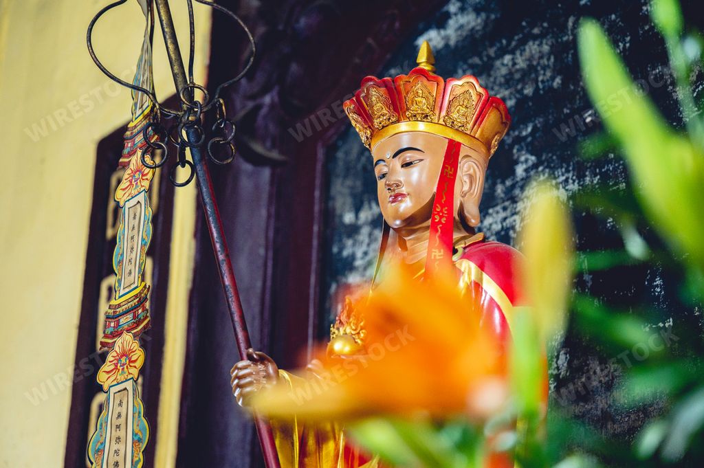 A closeup shot of a Buddhist idol decoration at an alter of a temple in Vietnam