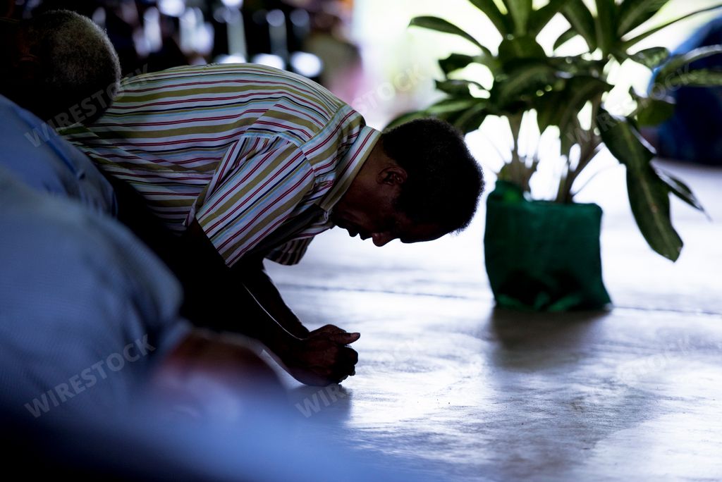 A man praying in a temple in Papua, New Guinea