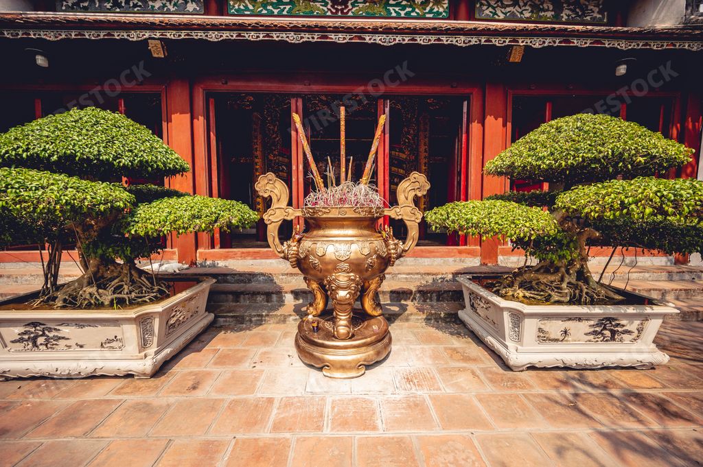 The burning incense on an altar of in front of a Buddhist Temple in Vietnam