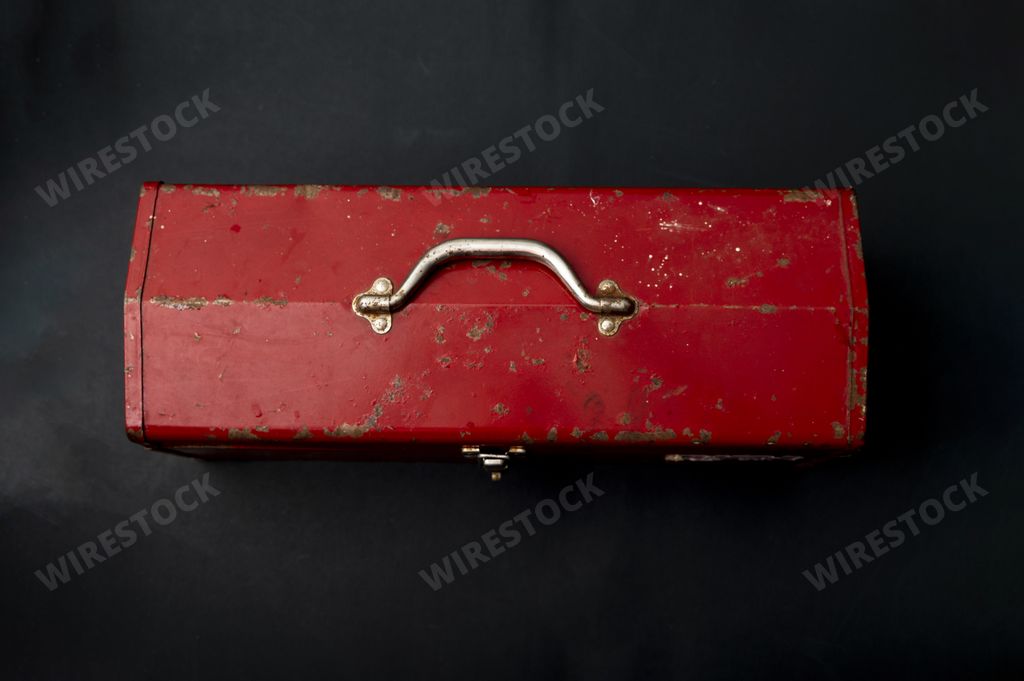 A top view of a red metal vintage suitcase