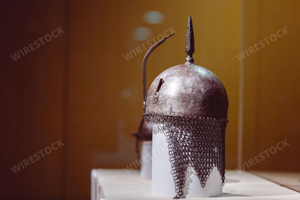 An ornate helmet with an intricate design behind a museum glass in Cairo, Egypt