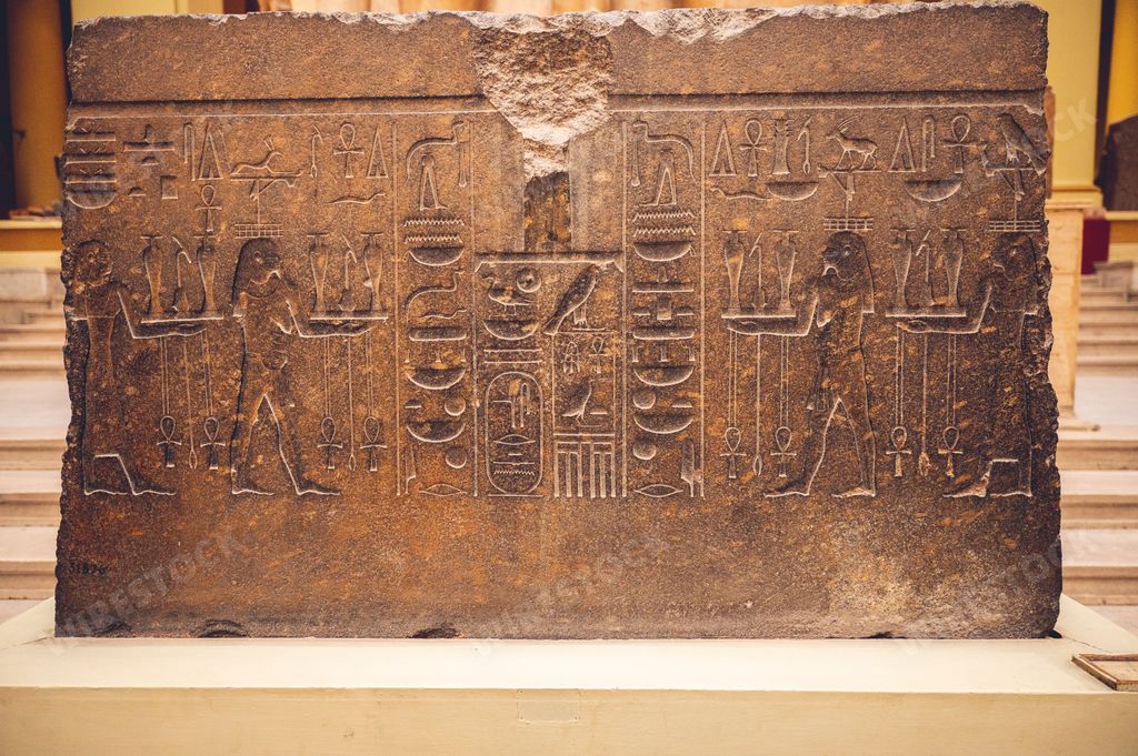 A slab of damaged stone engraved with depictions of pharaohs and hieroglyphs in the Egyptian Museum in Cairo