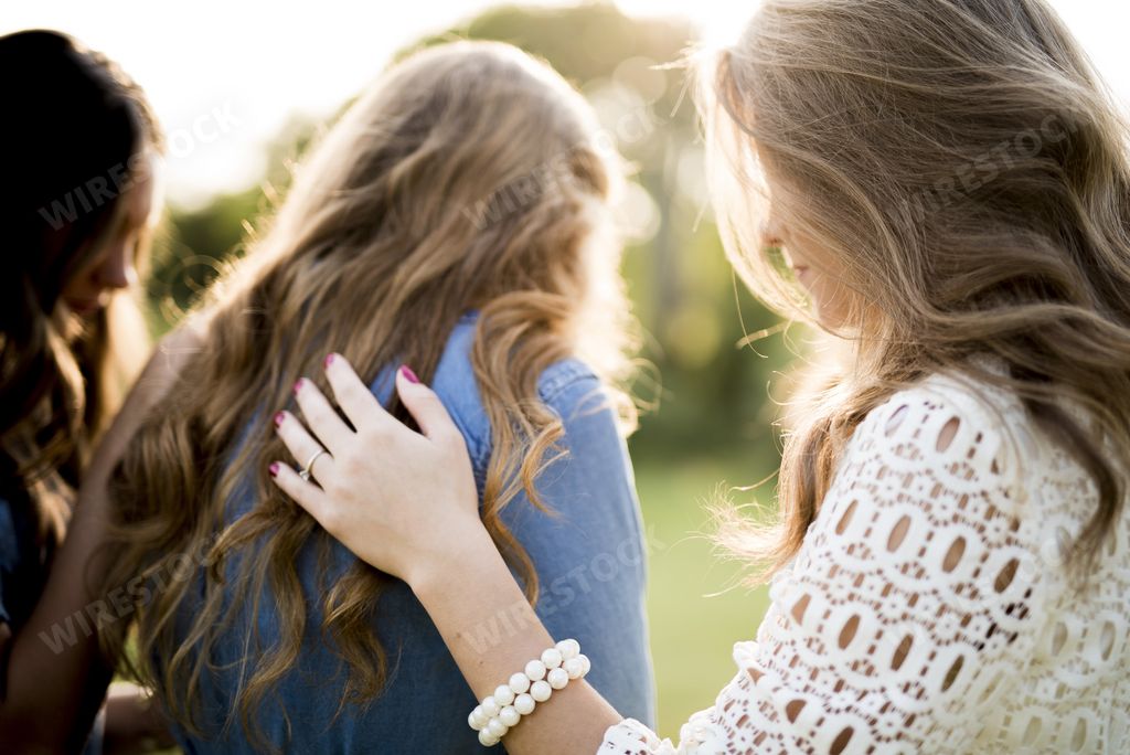 A closeup shot of a female blessing her friends with a blurred background