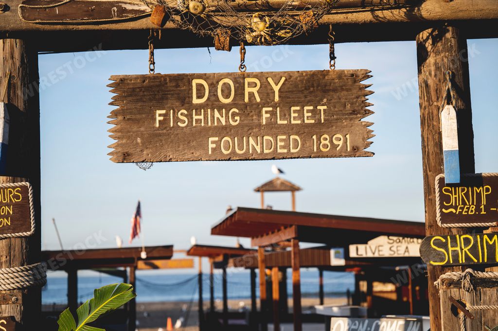 A wooden banner with the text "The Dory Fishing Fleet founded in 1891" in Newport Beach California