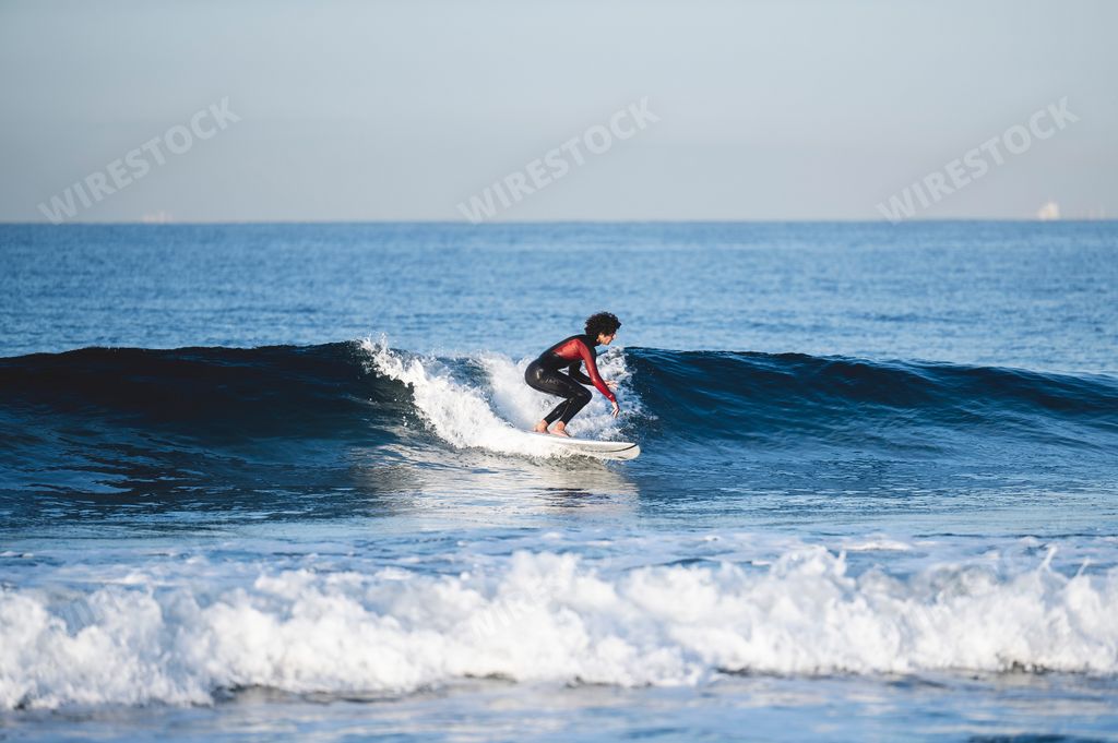 The surfer hitting the waves at Newport Beach California