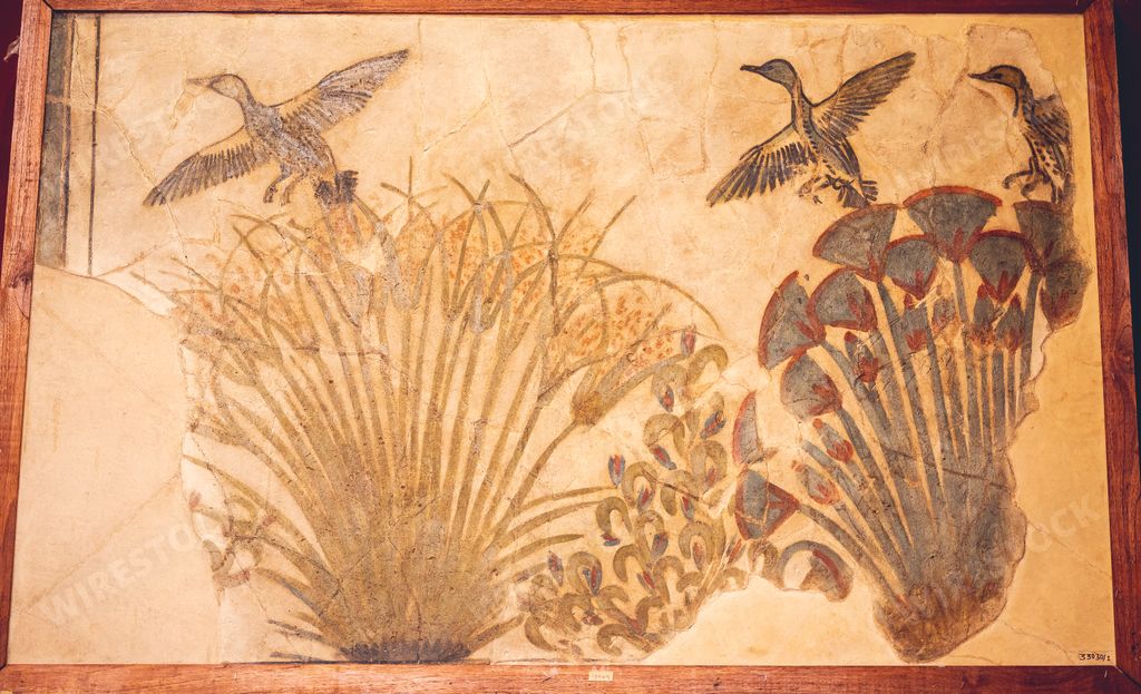 An ancient Egyptian artwork in the Egyptian Museum in Cairo depicting birds flying over flowers