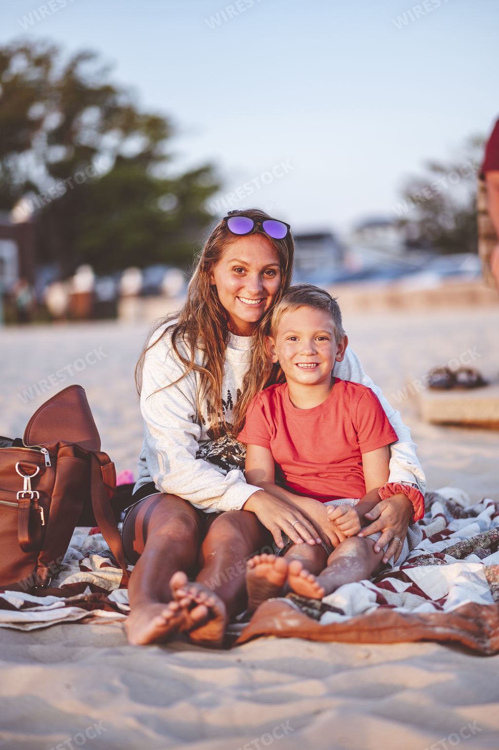 A closeup focus portrait of a mother and her son at the beach