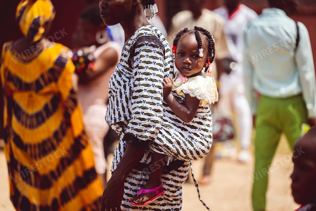A group of people in Abidjan, Cote d'Ivoire wearing bright, vibrant clothing
