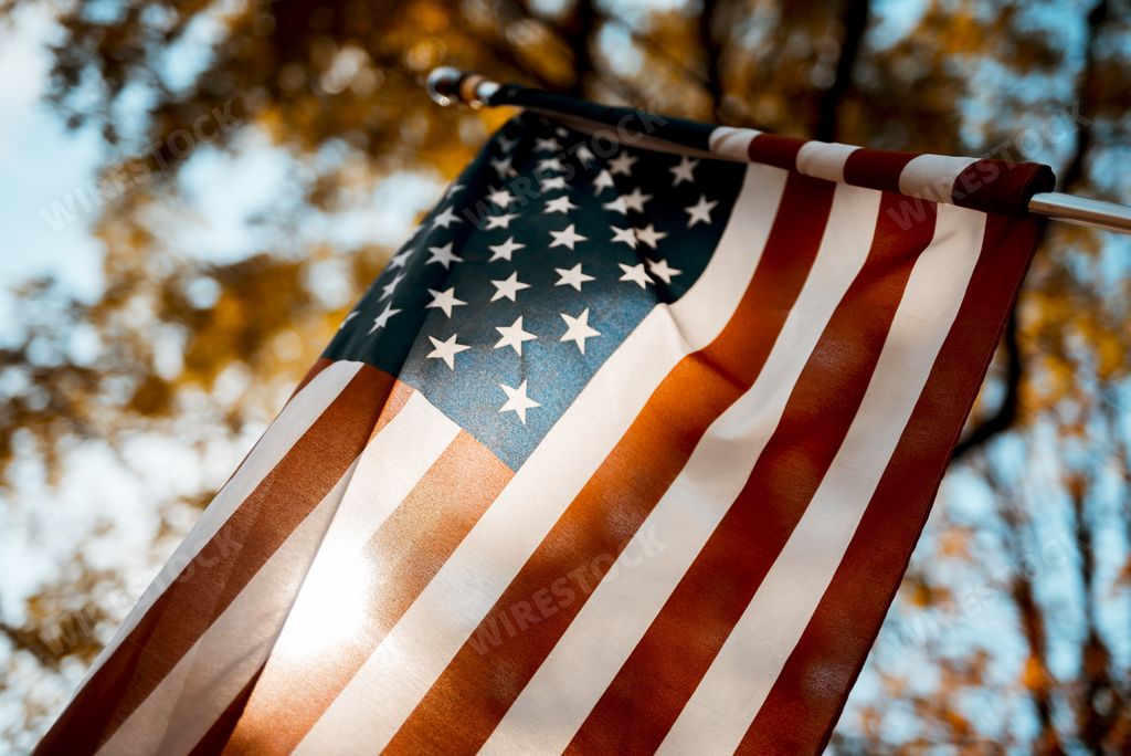 A flag of the united states shot from a low angle with a blurred background