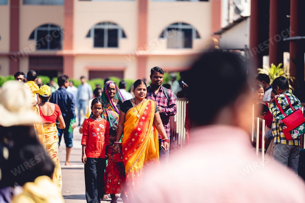 An Indian Hindu women worshiping at Hindu temple in traditional clothing on the chrome