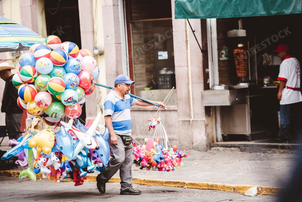 A typical day - a Hispanic vendor selling inflated toys on the streets of Zacatecas, Mexico