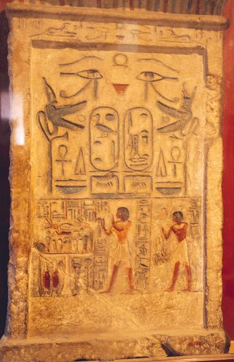 Closeup of an eye of Horus symbol on an aged orange stone