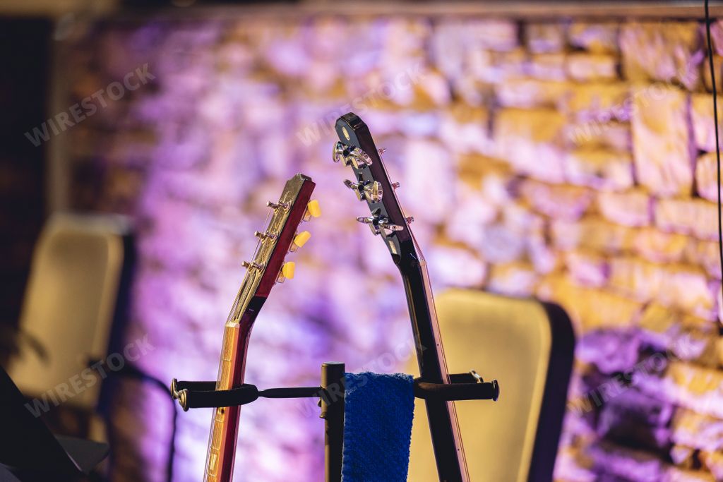 A closeup of two electric guitar headstocks.