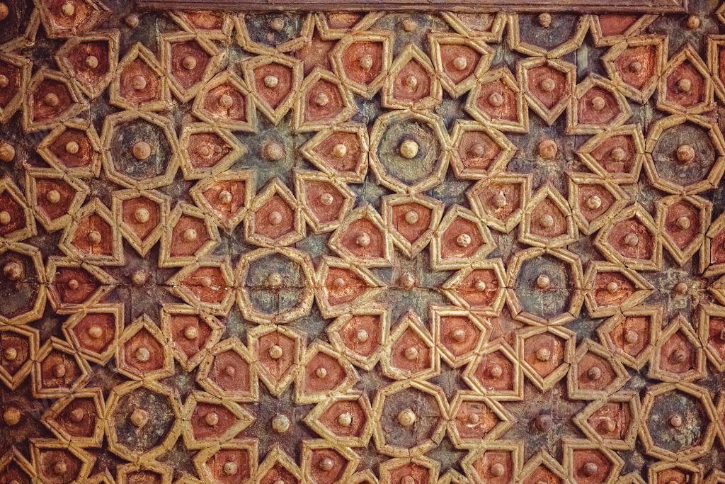 Ornate painted ceiling with intricate designs, wooden floor