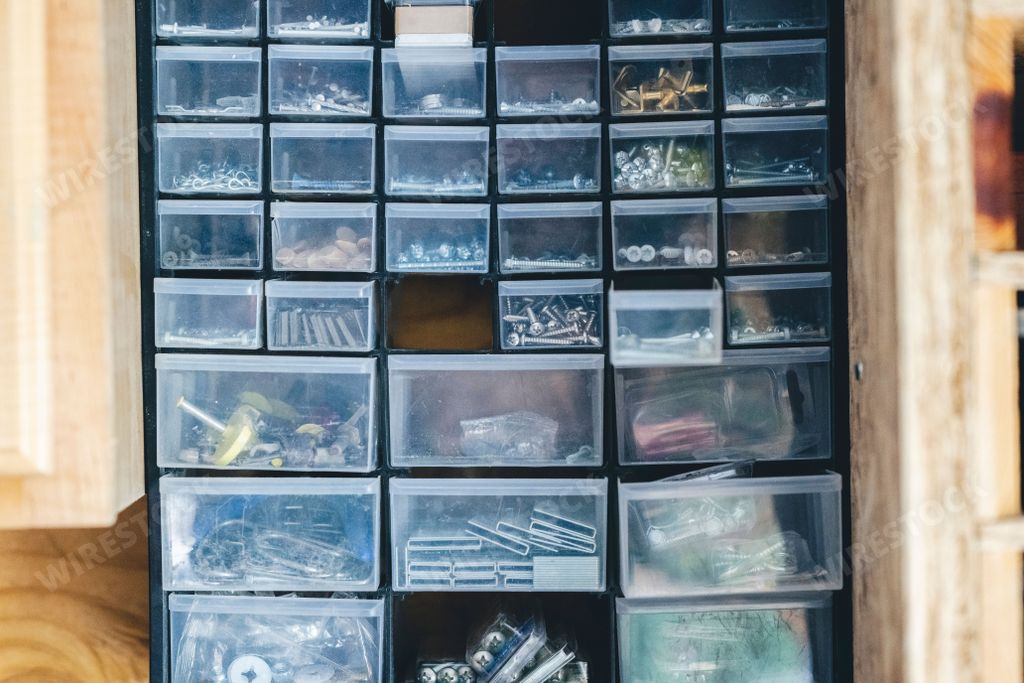 A variety of bolts, nuts, screws, and staples in a construction trailer