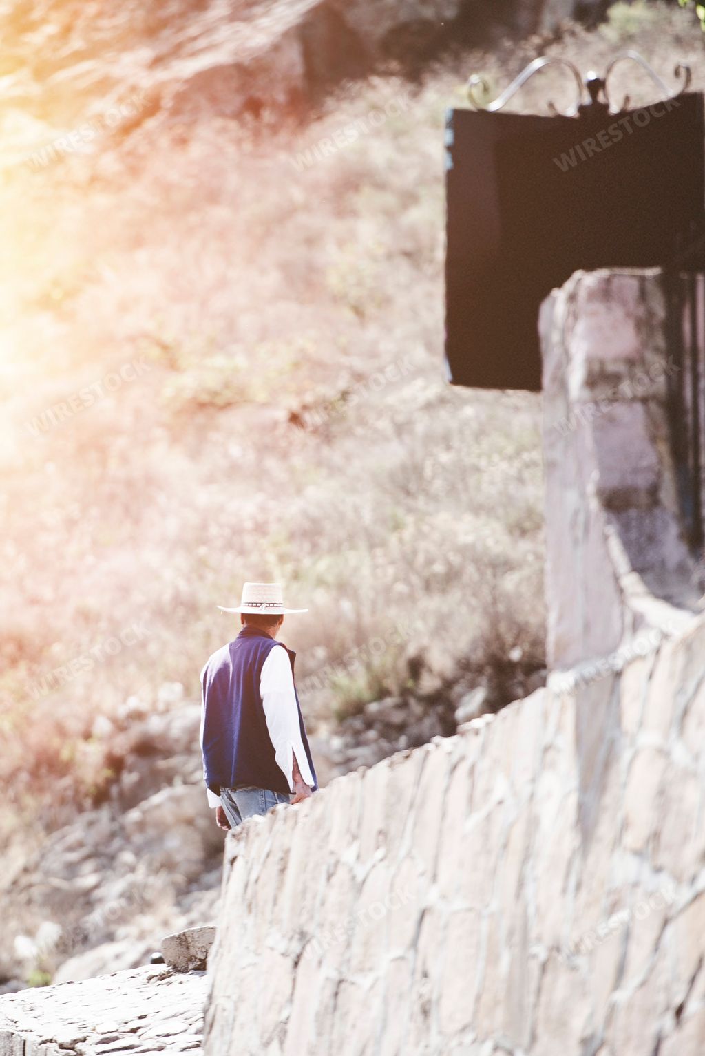 A Mexican cowboy walking against the Zacatecas landscape in Mexico
