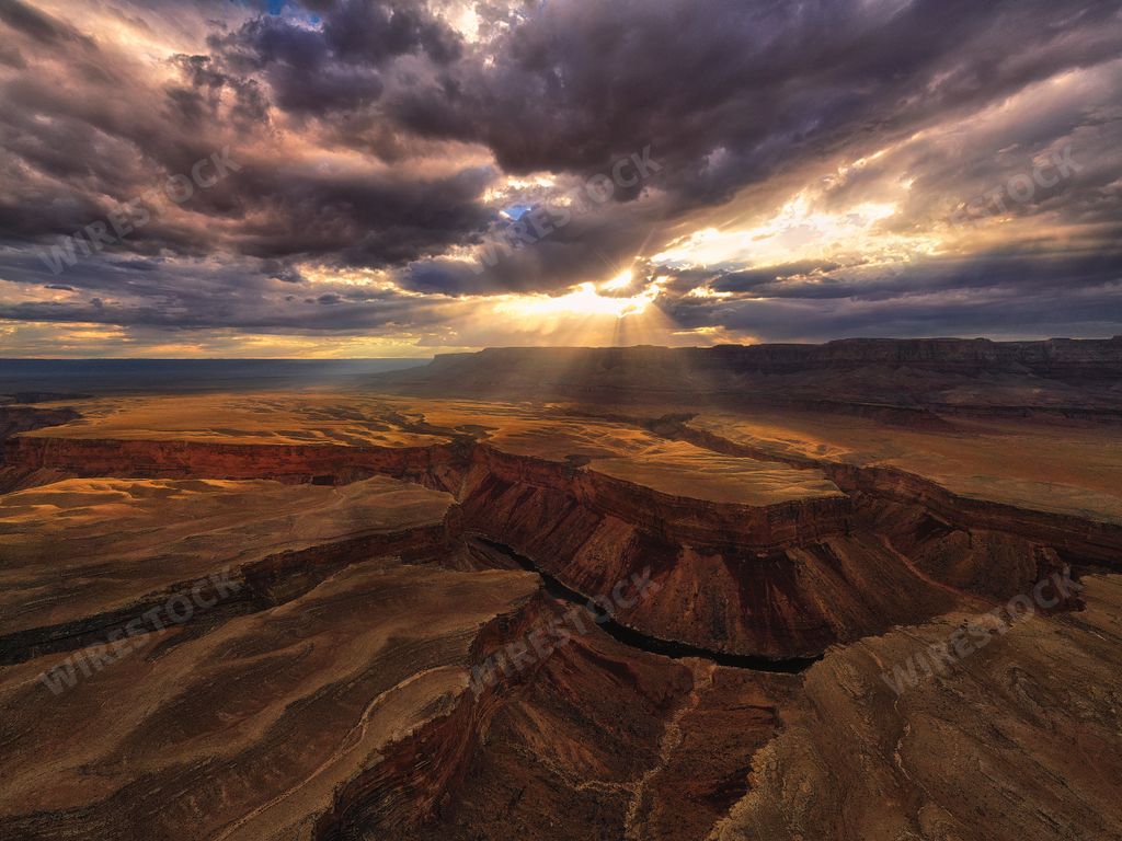 A breathtaking aerial view of the Grand Canyon and Colorado River at sunset