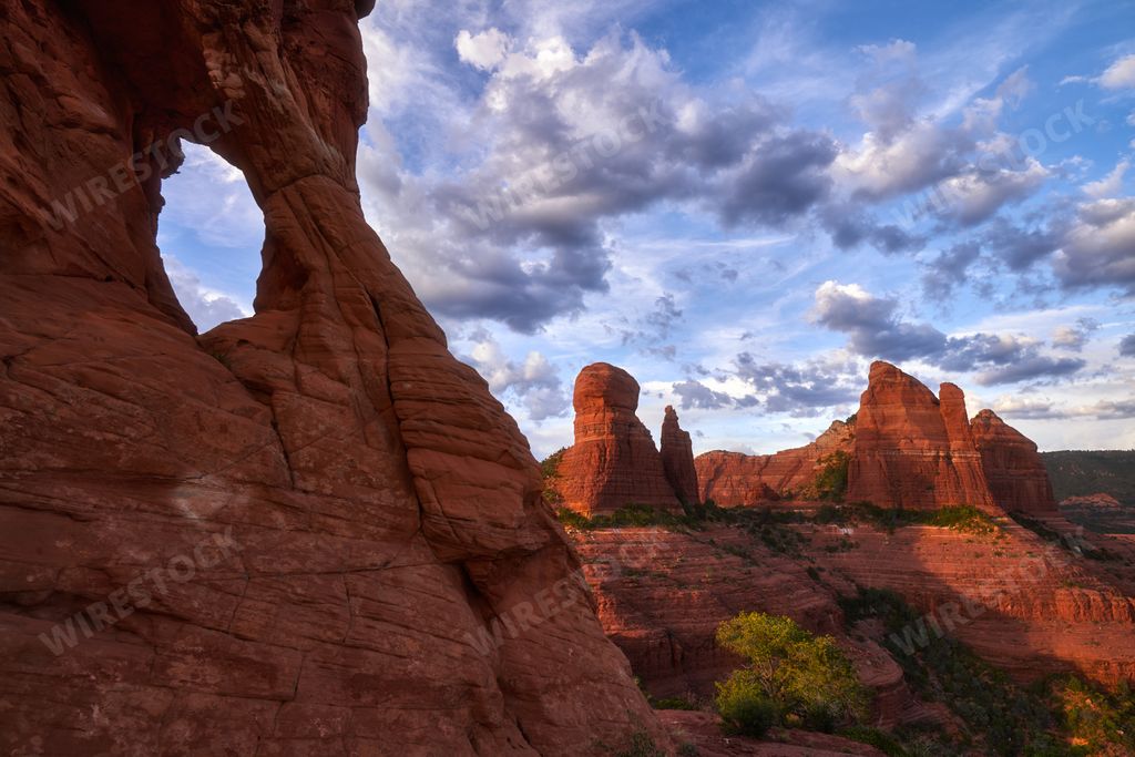 A rocky window and red rock formations in the scenic sky background, Mitten Ridge in Sedona, Arizona