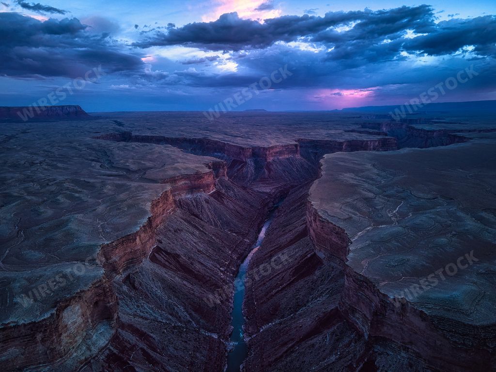 A breathtaking aerial view of the Grand Canyon and Colorado River at sunset