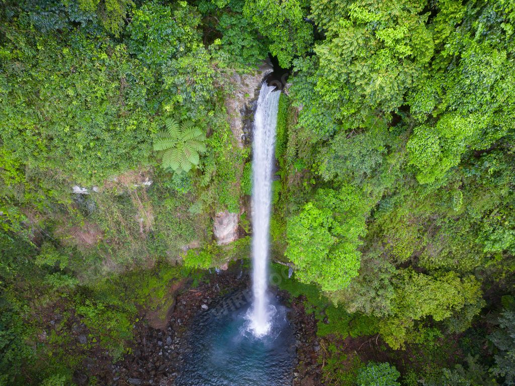 An aerial view of Katibawasan Falls, Camiguin island, Philippines