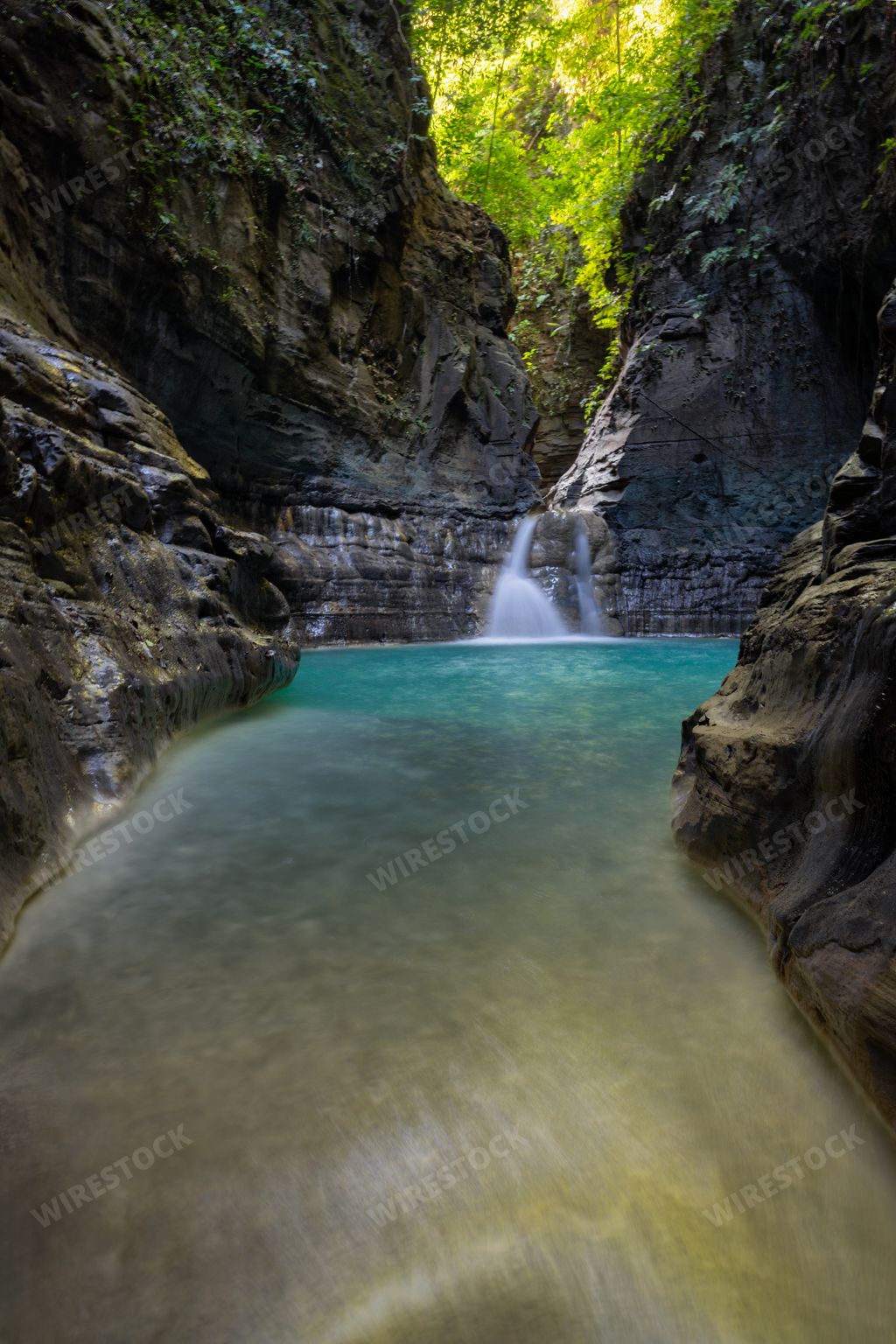 A scenic view of Air Terjun Wai Marang with a beautiful waterfall and cliffs. Sumba Island, Indonesia