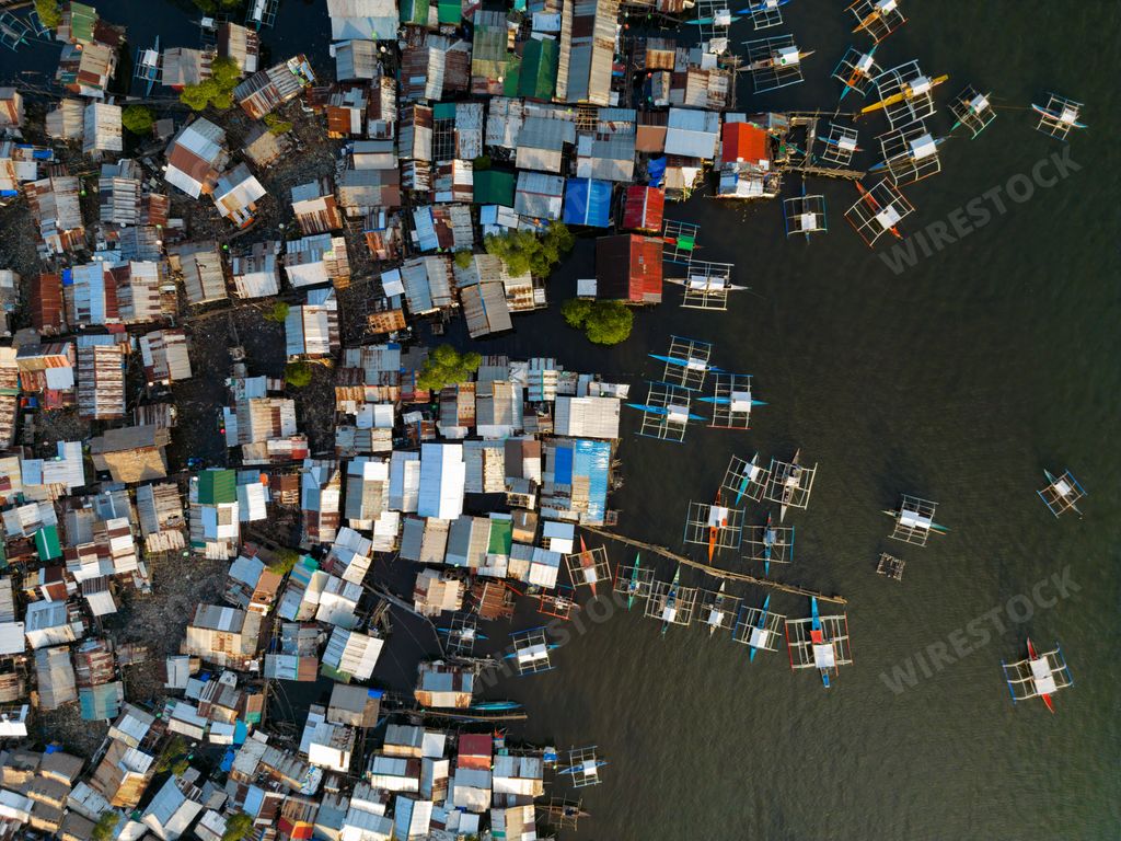 A vast body of water with numerous small boats bobbing on its surface