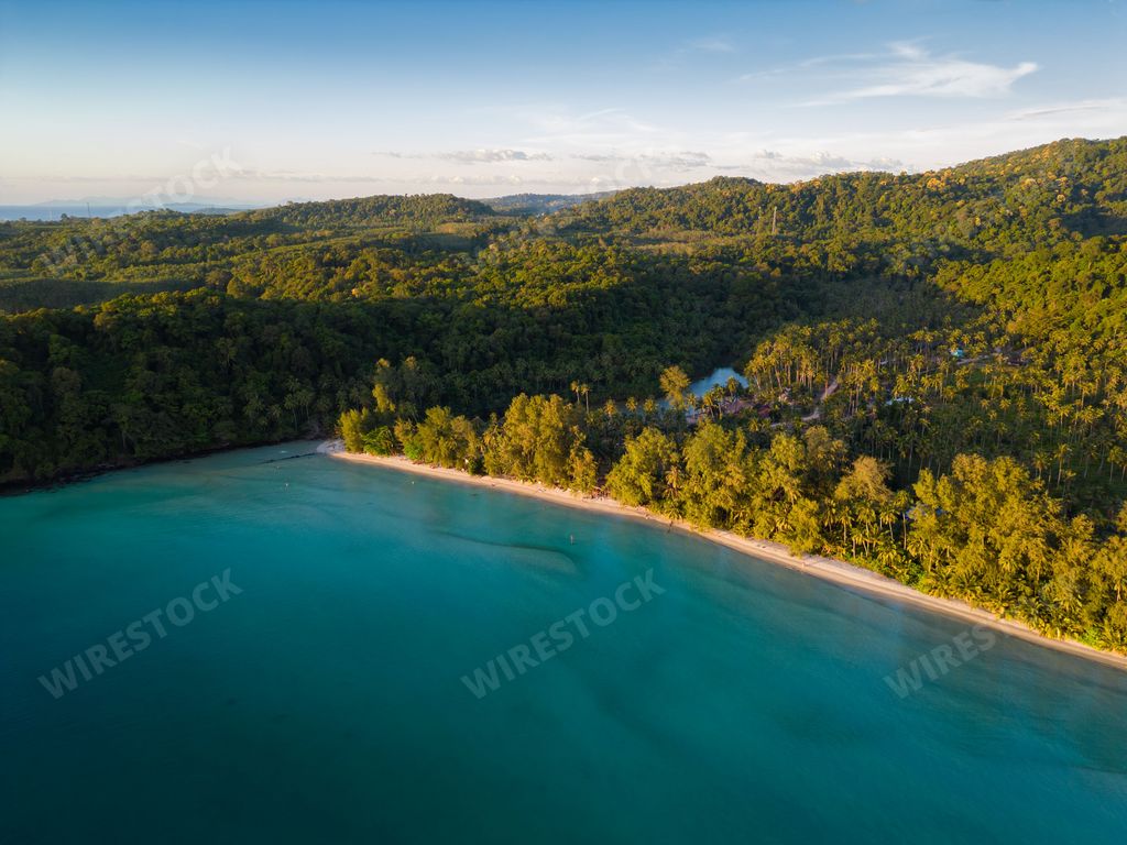 An aerial shot of the Ao Jak beach on Koh Kood island in Thailand surrounded by the blue sea