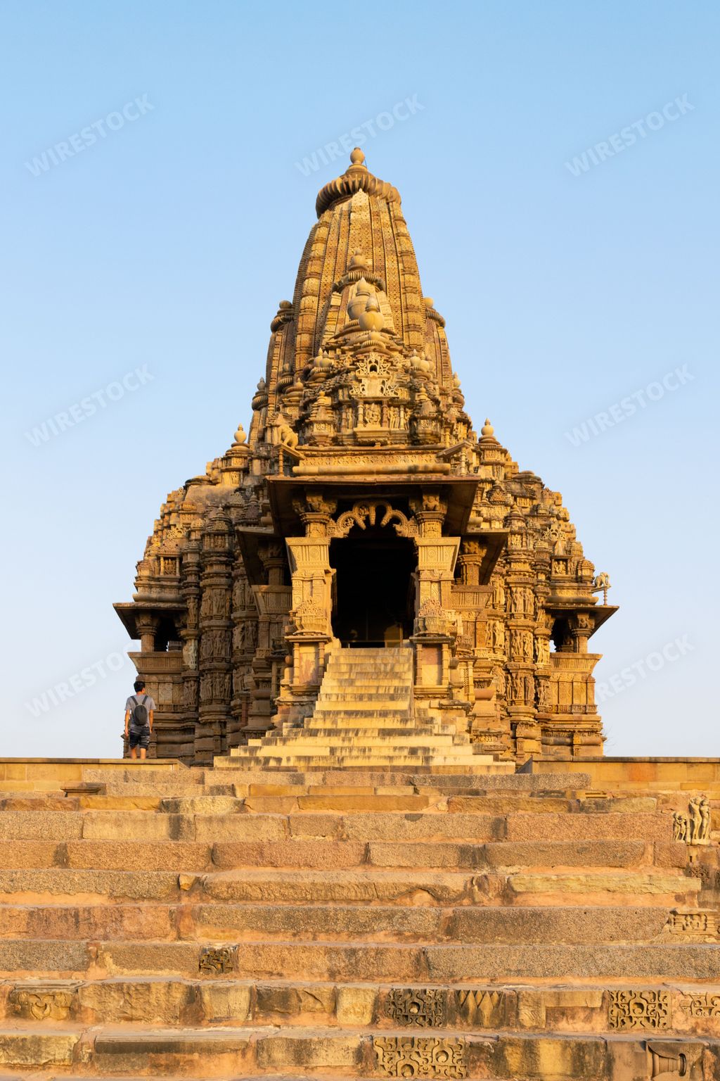 A vertical shot of Kandariya Mahadev Temple against blue sky background in India