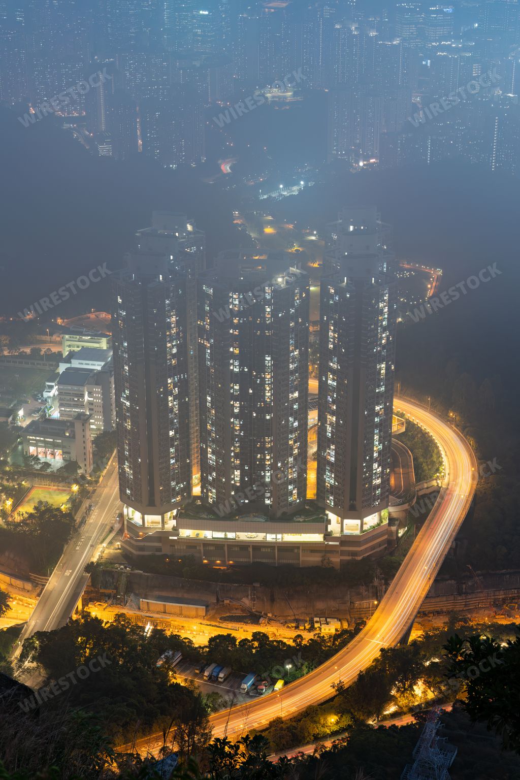 A foggy night in a bustling city with high-rise buildings. Hong Kong