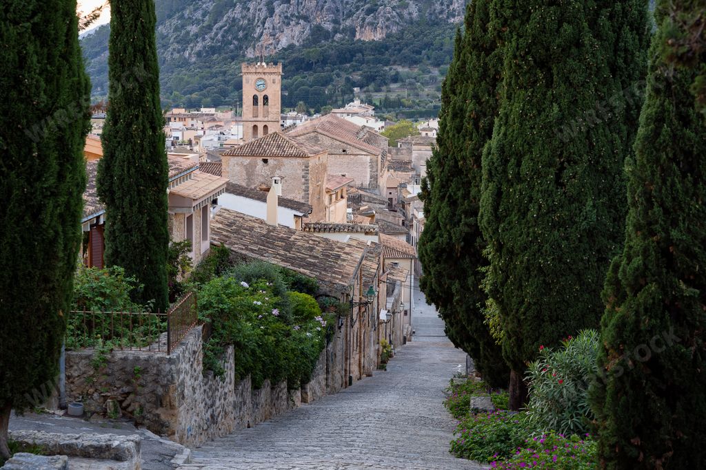 A path surrounded by aged buildings in Pollenca, Mallorca (Majorca) Balearic Islands, Spain
