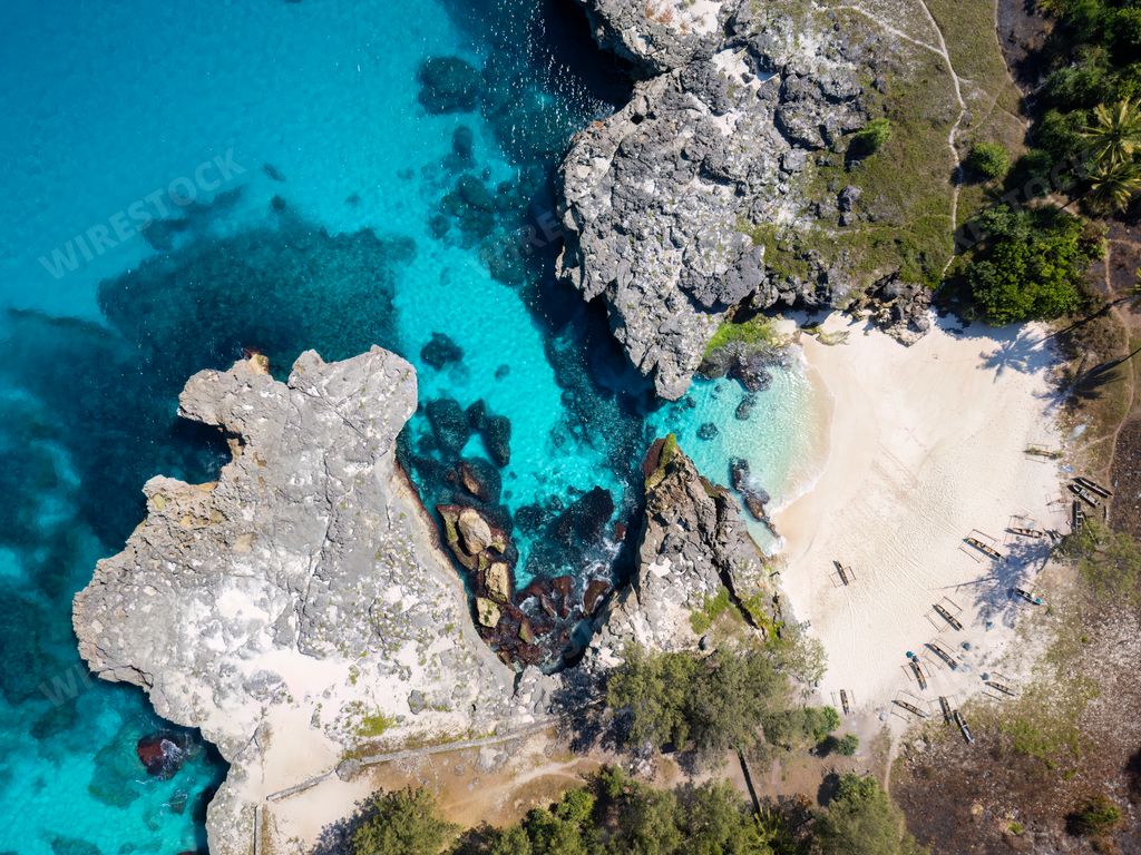 An aerial view of Pantai Mandorak with turquoise waters and cliffs. Sumba Island, Indonesia