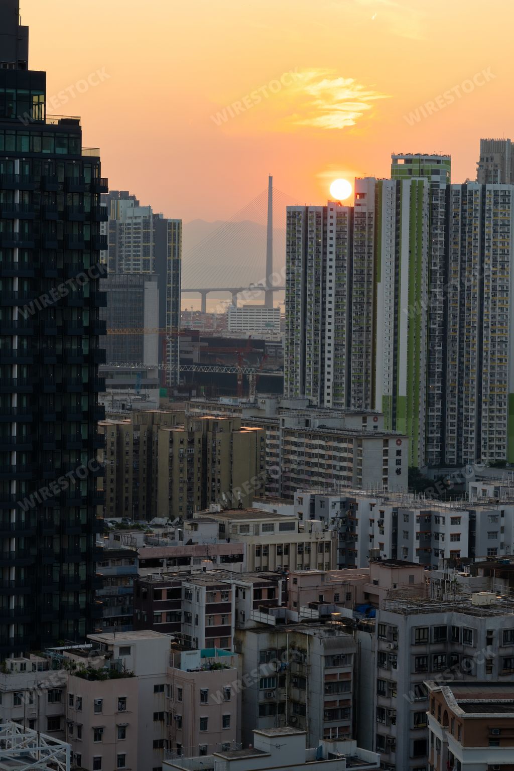 Cityscape with sunset behind distant high-rise buildings