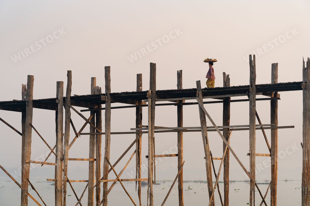A scenic sunrise with monks on U Bein Bridge in Mandalay, Myanmar (Burma)