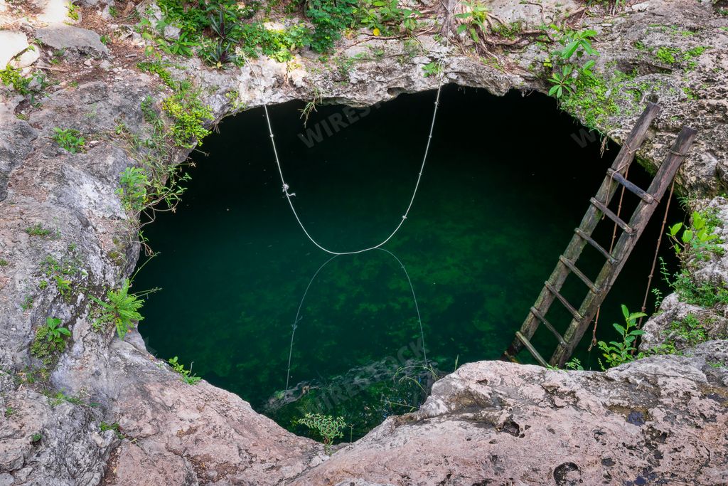 A closeup shot of the Cenote Calavera tourist attraction in Tulum, Mexico