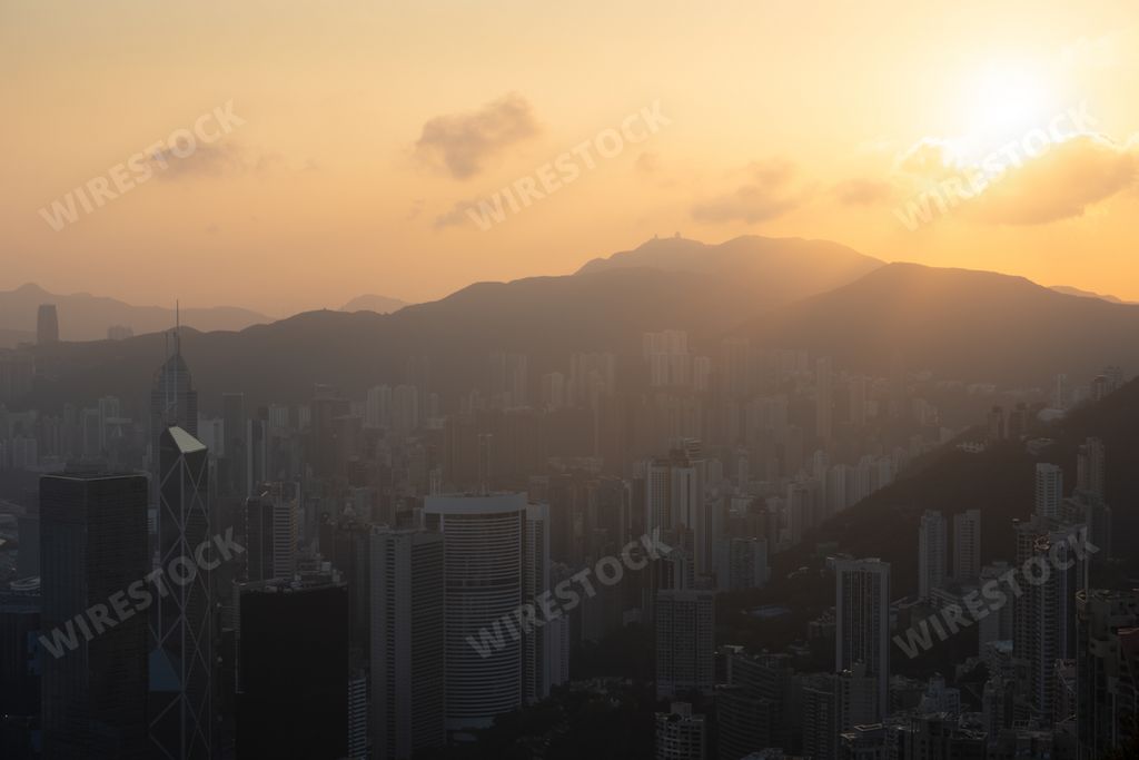 The golden hour at sunrise over Hong Kong skyscrapers seen from Victoria Peak