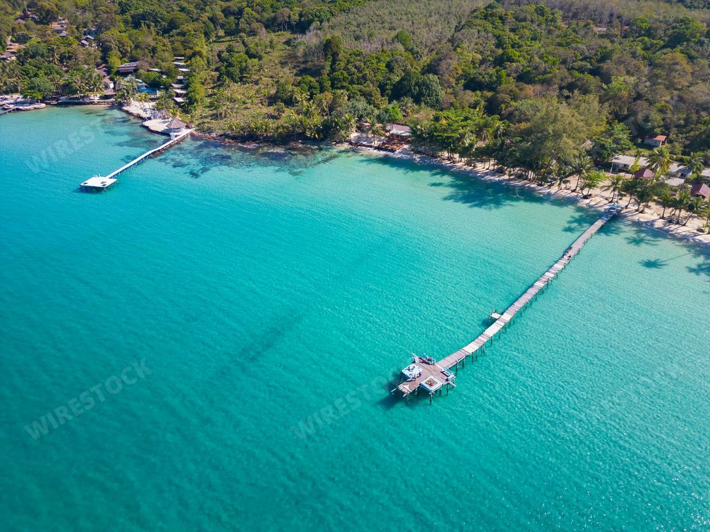 An aerial shot of wooden docks at the Bang bao beach in Koh Kood, Thailand on a sunny day